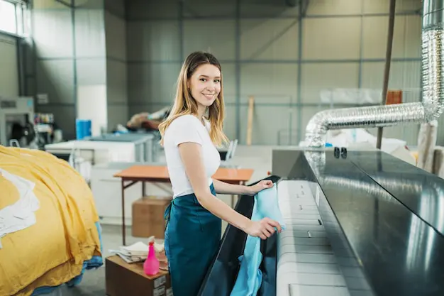 young laundry worker pats linen automatic machine dry cleaners 473712 2651